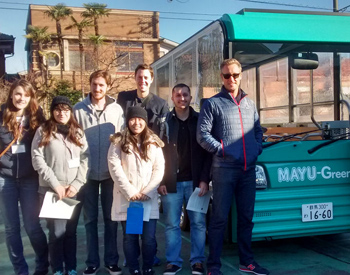Group in front of electric bus