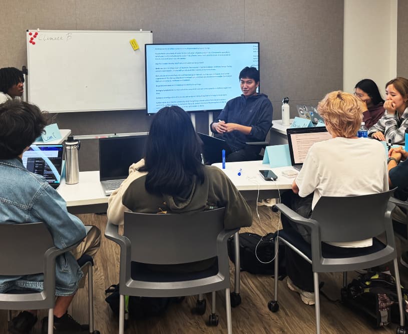 A group of students in a classroom participating in a discussion.