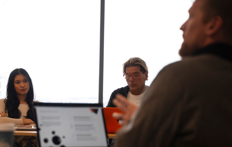 Students and an instructor engaged in a classroom discussion.