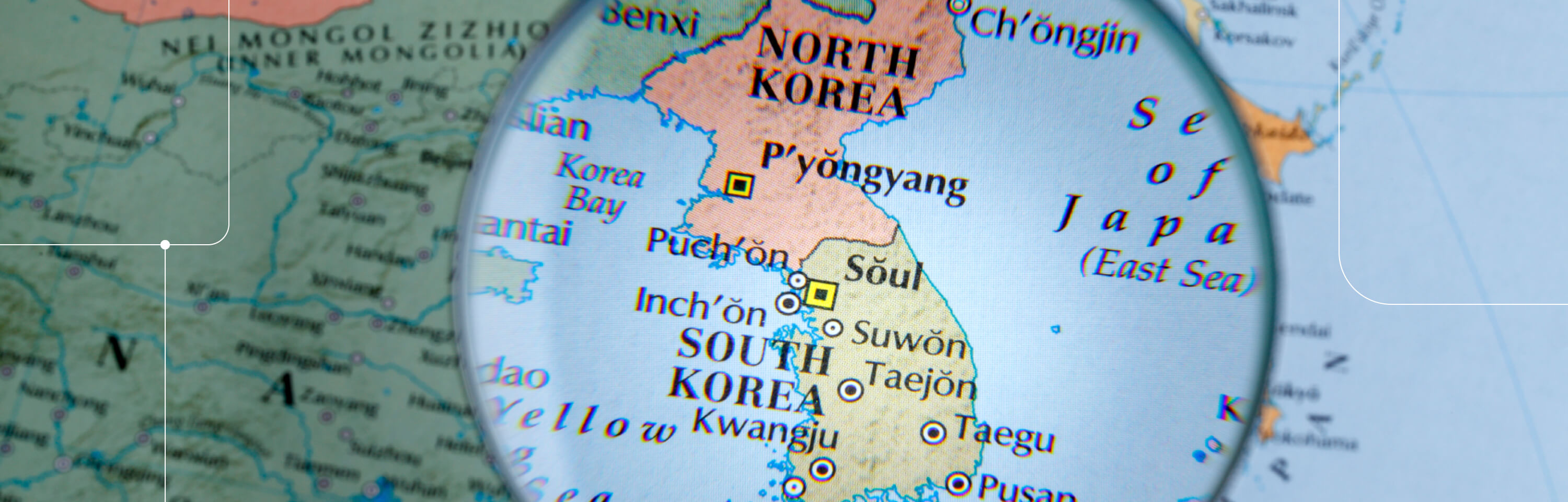 Map with a magnifying glass over North and South Korea