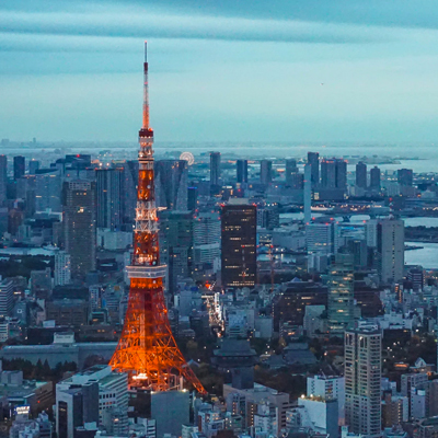 Photo of Tokyo with buildings and the Tokyo Tower in the foreground